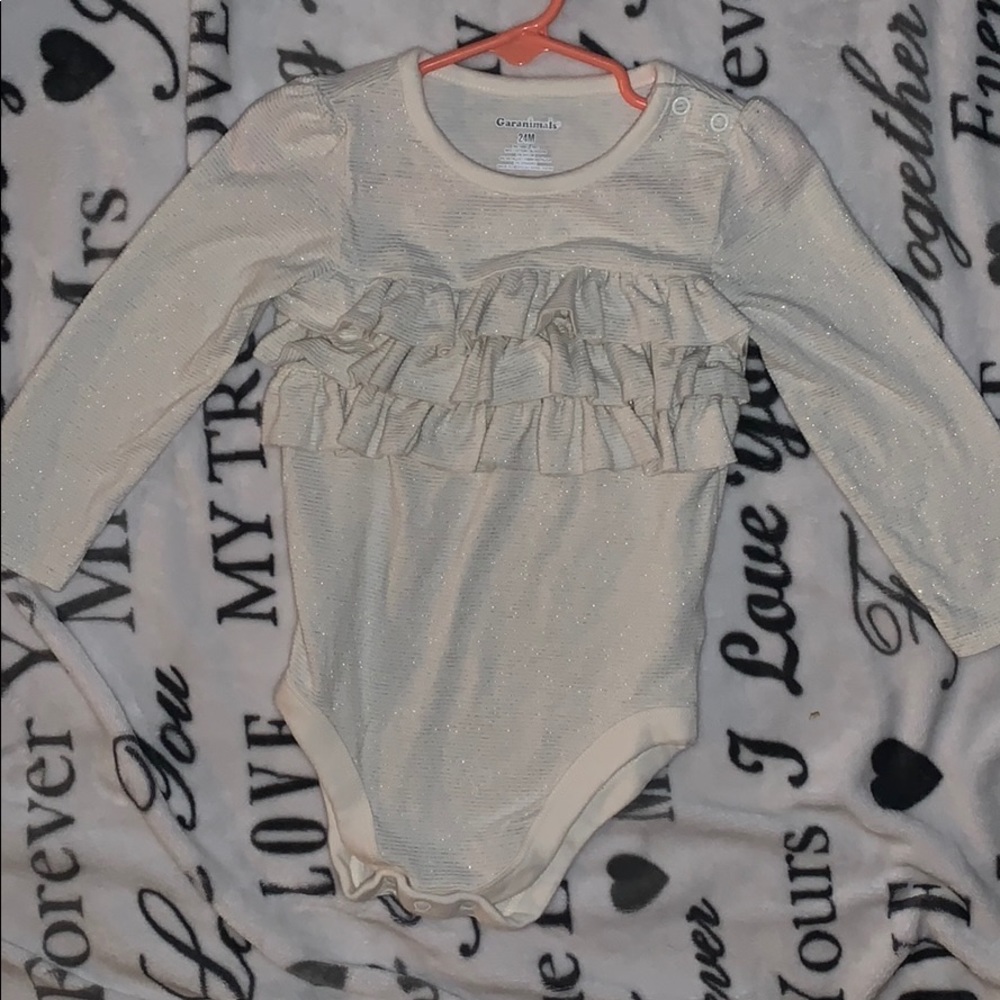 Stretchy onesie with ruffles and glitter strips!